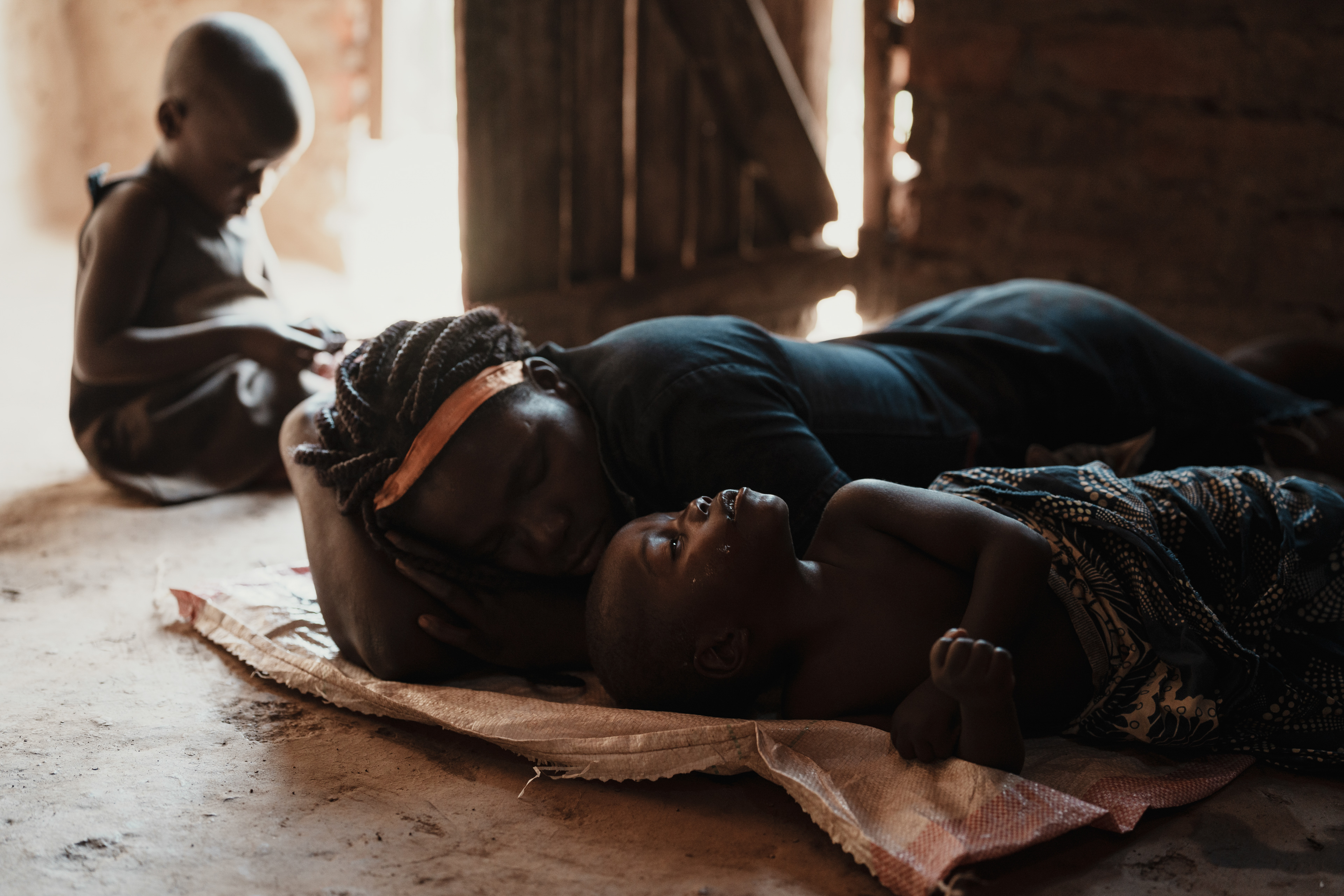 Manica, Mozambique, 15/02/2024 — Ruarache cares for son Gerson, with neurological issues, while husband Romio mines gold for their family.