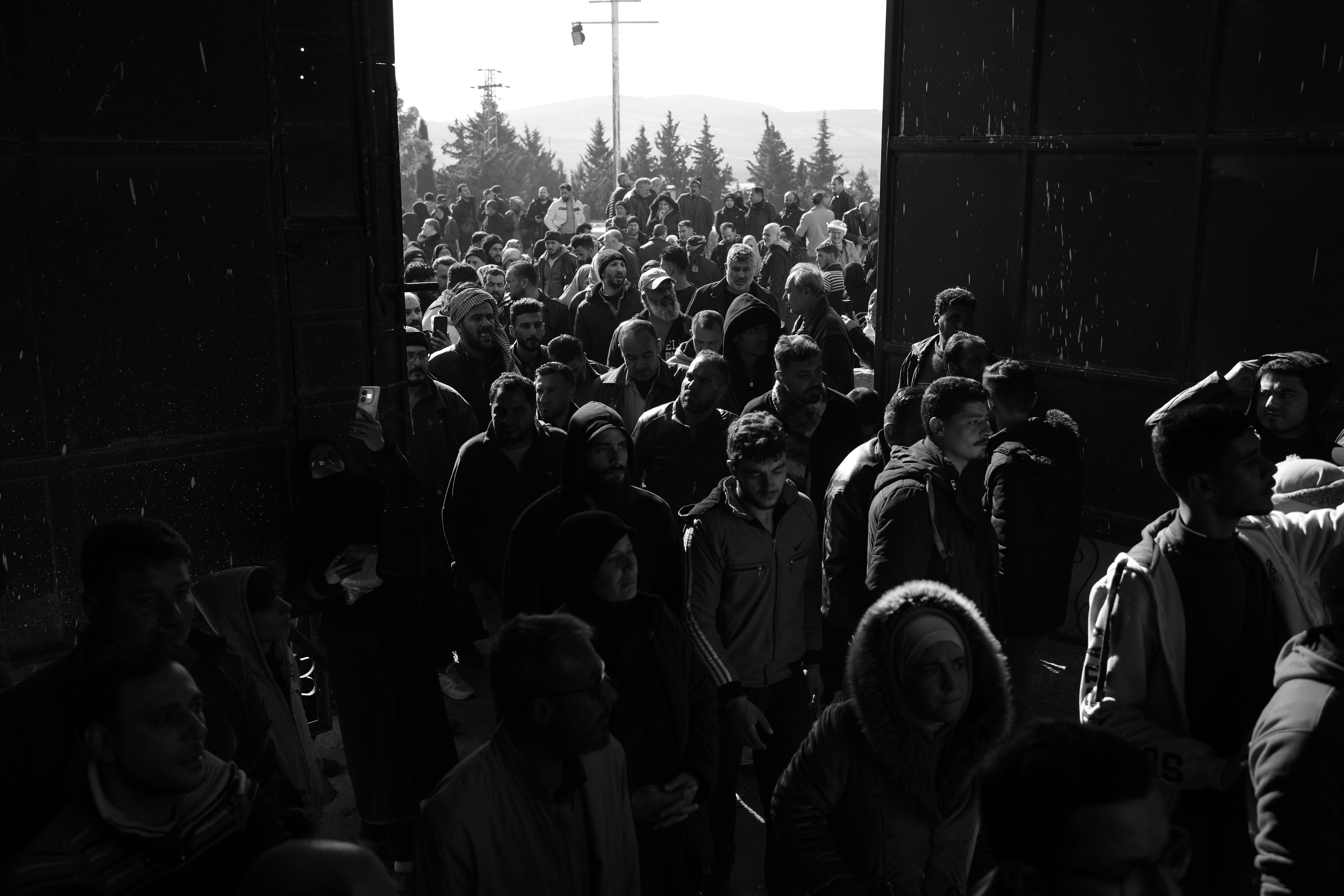 DAMASCUS, SYRIA - DECEMBER 9: Crowds enter the gates at Sednaya Prison to look for their loved ones after the fall of the Syrian regime.