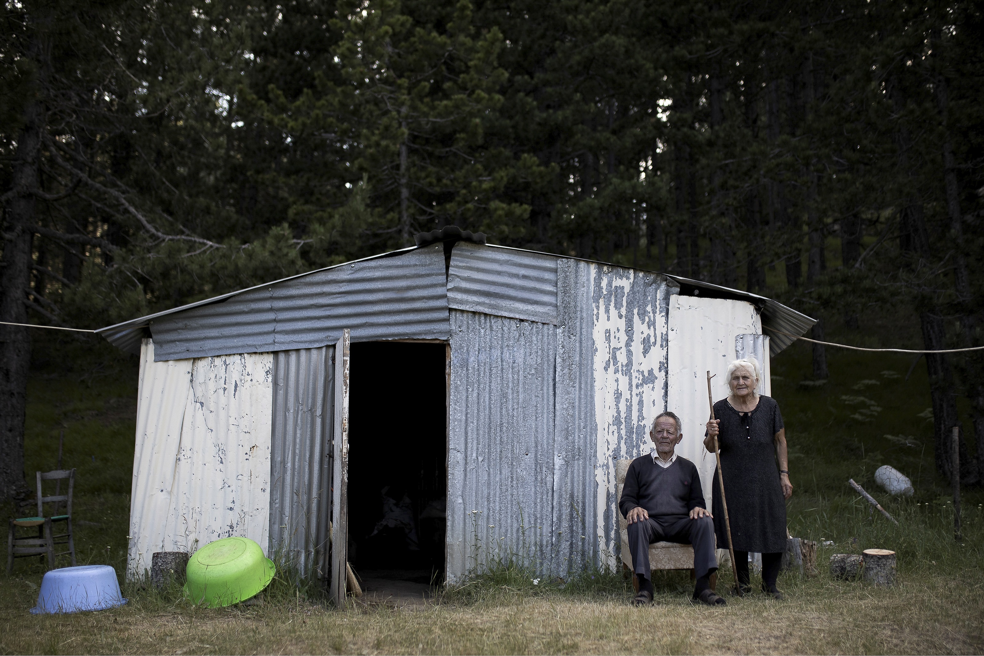 Diava: an elderly shepherd couple, N.Tzimas (84) and E.Tzima (80), pose for a photo outside their makeshift hut on a plateau of Mt Smolikas, Greece.
